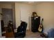 Home office with a desk, chair, filing cabinet, and a guitar, creating a functional workspace at 2566 Summit Cove Dr, Duluth, GA 30097