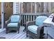 Comfortable outdoor patio with wicker chairs, soft blue cushions, and a rustic wooden fence at 2566 Summit Cove Dr, Duluth, GA 30097