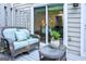 Cozy patio seating area with a plush loveseat, glass table, and view into the home at 2566 Summit Cove Dr, Duluth, GA 30097