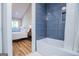 A sleek bathroom with blue tiling around the tub and a glimpse of the bedroom at 294 Clearview Ct, Villa Rica, GA 30180