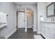 Modern bathroom with open entry to toilet and gray tile floor, a white vanity, and towel rack at 294 Clearview Ct, Villa Rica, GA 30180