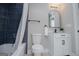This well-lit bathroom has dark blue tiled shower surround and a white vanity at 294 Clearview Ct, Villa Rica, GA 30180