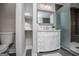 Modern bathroom with vanity, toilet, open shelves with towels, decorative mirror and glass enclosed shower at 294 Clearview Ct, Villa Rica, GA 30180