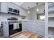 Modern kitchen features stainless steel appliances, gray cabinetry, quartz countertops, and recessed lighting at 294 Clearview Ct, Villa Rica, GA 30180