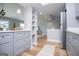 Bright and airy kitchen with gray cabinets, quartz countertops, stainless appliances, and open shelving at 294 Clearview Ct, Villa Rica, GA 30180