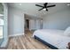 Bright main bedroom featuring a ceiling fan, wood floors, an ensuite and a sliding glass door to deck at 294 Clearview Ct, Villa Rica, GA 30180