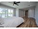 Bright main bedroom featuring a ceiling fan, wood floors, and sliding glass door to deck with a lake view at 294 Clearview Ct, Villa Rica, GA 30180