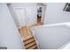 View from the top of a light and bright stairwell featuring wood-look floors and a white front door at 294 Clearview Ct, Villa Rica, GA 30180
