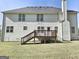 Back of a two-story home with white siding and a wooden deck at 247 Water Oak Ln, Jonesboro, GA 30238
