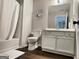 Clean bathroom with a white vanity, toilet, and shower-tub combination with stylish fixtures at 247 Water Oak Ln, Jonesboro, GA 30238