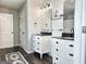 Bathroom with dual vanity, dark wood floor, and decorative lighting at 247 Water Oak Ln, Jonesboro, GA 30238