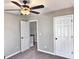 Bedroom featuring neutral paint, ceiling fan, and a doorway view of the staircase at 247 Water Oak Ln, Jonesboro, GA 30238