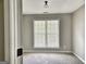 Bedroom featuring neutral walls, carpet, and a window with natural light at 247 Water Oak Ln, Jonesboro, GA 30238