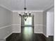 Dining area with chandelier, hardwood floors and view to kitchen at 247 Water Oak Ln, Jonesboro, GA 30238