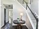 Foyer with a table and a staircase with white railings and dark banisters at 247 Water Oak Ln, Jonesboro, GA 30238