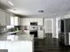 Open concept kitchen with white cabinets, stainless steel appliances, and granite countertops at 247 Water Oak Ln, Jonesboro, GA 30238