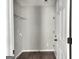 Functional laundry room features shelving, hardwood floors, and neutral paint at 247 Water Oak Ln, Jonesboro, GA 30238
