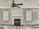 Cozy living room showcasing fireplace, ceiling fan, and natural light at 247 Water Oak Ln, Jonesboro, GA 30238