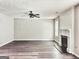 Inviting living room with fireplace, ceiling fan, and wood flooring at 247 Water Oak Ln, Jonesboro, GA 30238