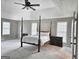 Bright main bedroom with tray ceiling, ceiling fan, neutral walls, and two large windows at 247 Water Oak Ln, Jonesboro, GA 30238