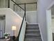 Carpeted staircase with white railings and black banisters at 247 Water Oak Ln, Jonesboro, GA 30238