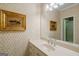 Well-lit bathroom featuring a vanity with sink and decorative wallpaper at 3644 Graycliff Rd, Snellville, GA 30039