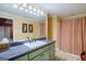 Bathroom with black countertop, tan floor tiles, and warm yellow walls at 3644 Graycliff Rd, Snellville, GA 30039