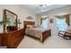 Bedroom with a wooden bed, dresser, large windows, carpeted floor, and rocking chair at 3644 Graycliff Rd, Snellville, GA 30039