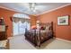 Cozy bedroom with a decorative metal bed frame, ceiling fan, and a large window at 3644 Graycliff Rd, Snellville, GA 30039