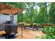 Wooden deck featuring a built-in grill and a view of the backyard at 3644 Graycliff Rd, Snellville, GA 30039