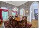 Formal dining room with designer wallpaper and a chandelier at 3644 Graycliff Rd, Snellville, GA 30039