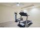 Carpeted home gym boasts an elliptical, treadmill, and ceiling fan at 3644 Graycliff Rd, Snellville, GA 30039