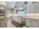 Kitchen with granite countertops, stainless steel appliances, white cabinets, and a large window at 3644 Graycliff Rd, Snellville, GA 30039