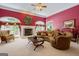 Elegant living room with fireplace, rounded windows, and plush seating at 3644 Graycliff Rd, Snellville, GA 30039
