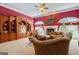 Cozy living room featuring a fireplace, built-in shelving, and large windows for plenty of natural light at 3644 Graycliff Rd, Snellville, GA 30039