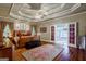 Spacious main bedroom with hardwood floors and access to a luxurious en-suite bathroom at 3644 Graycliff Rd, Snellville, GA 30039