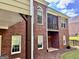 Well-maintained brick home featuring a balcony and covered patio, ideal for outdoor living and entertainment at 6680 Bentley Trl, Cumming, GA 30040