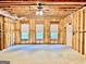 Unfinished basement featuring framing with insulation, large windows, and concrete flooring at 6680 Bentley Trl, Cumming, GA 30040