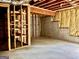 Unfinished basement featuring wood framing, concrete walls, insulation, and a concrete floor at 6680 Bentley Trl, Cumming, GA 30040