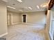 Finished basement with carpet, recessed lighting, and neutral paint; closet and door at 6680 Bentley Trl, Cumming, GA 30040
