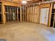 Unfinished basement showcasing framing, ceiling pipes, and doorway, ready for customization at 6680 Bentley Trl, Cumming, GA 30040