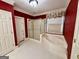 Elegant bathroom featuring a bathtub, a walk-in shower, and sophisticated red walls at 6680 Bentley Trl, Cumming, GA 30040