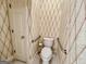 A small bathroom with grab bars, a toilet, and patterned wallpaper at 6680 Bentley Trl, Cumming, GA 30040