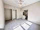 Spacious primary bedroom with neutral colors, ceiling fan, carpet and ensuite at 6680 Bentley Trl, Cumming, GA 30040