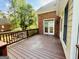View of the outdoor deck with wood flooring and railing and exterior view of the home at 6680 Bentley Trl, Cumming, GA 30040