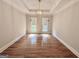 Dining room featuring hardwood floors, tray ceiling, and natural light at 6680 Bentley Trl, Cumming, GA 30040