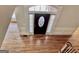 Elegant entryway with decorative door and trim, hardwood floors and grand staircase at 6680 Bentley Trl, Cumming, GA 30040