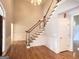Grand foyer with hardwood floors, chandelier, and a classic staircase design at 6680 Bentley Trl, Cumming, GA 30040