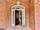 Elegant front entryway with a decorative wooden door and arched glass pane at 6680 Bentley Trl, Cumming, GA 30040