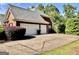 Spacious three-car garage with ample parking space and a well-maintained driveway at 6680 Bentley Trl, Cumming, GA 30040